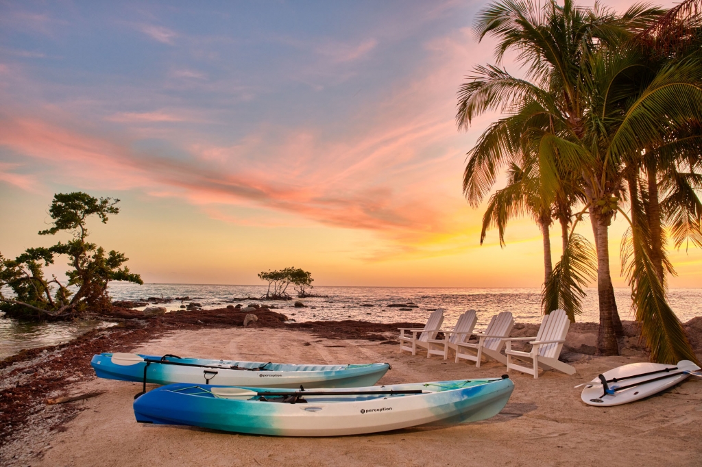 canoe and kayak on the beach against the sunset