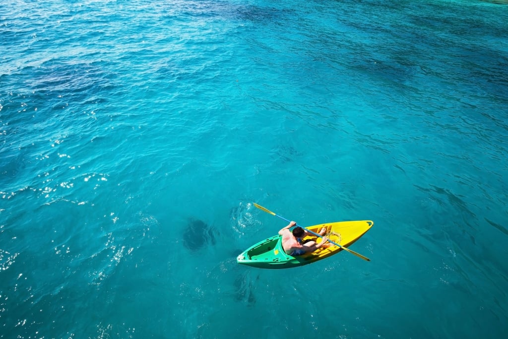 solo kayaker in a blue sea