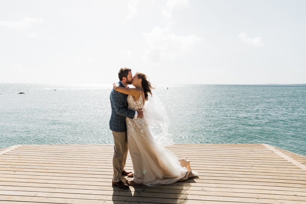 married couple stood in front of the sea