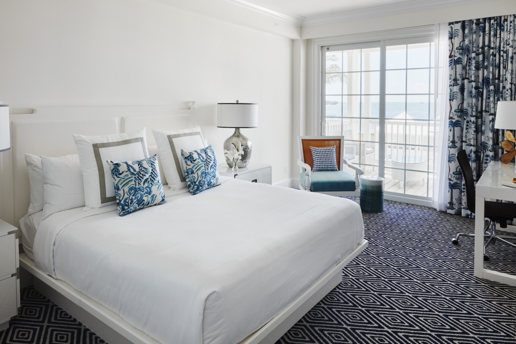 hotel suite with large bed and blue cushions