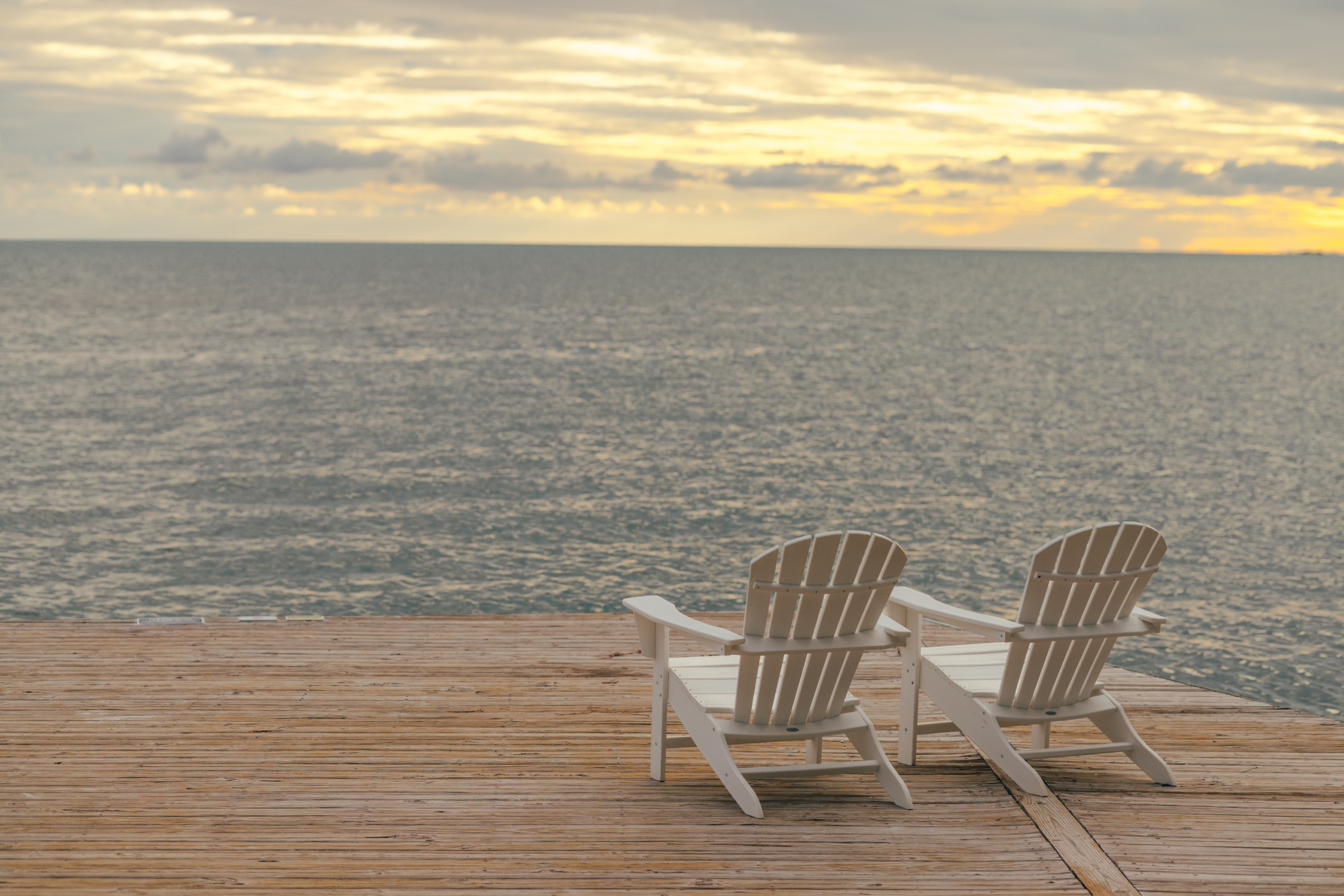 pelican point two sunloungers overlooking sunset over the sea