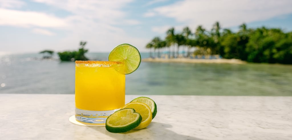 a yellow cocktail sat on a table