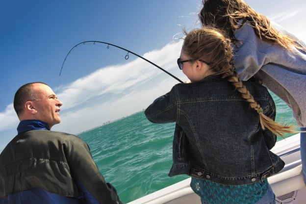 family enjoying sea fishing off the coast