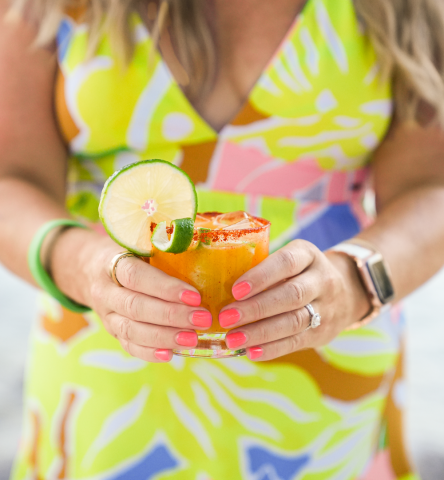 lady holding orange cocktail